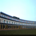 Modern School Building With Curved White Exterior Blue Accents Yellow Pillars And Glass Windows