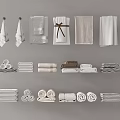 Various Folded and Hanging Towels in Neutral Colors for Bathroom Decor