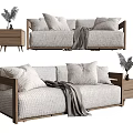 Two Seater Sofa With Light Fabric Pillows And Wooden Side Table Potted Plant