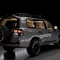 Tough Off Road Toyota SUV with Dark Colored Body Roof Rack Large Wheels and Beige Interior