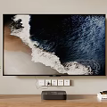 Wall Mounted TV Displaying Ocean Waves In Living Room With Soundbar Potted Plant And Books