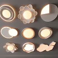 Modern Lighting Fixture Set With Various Shapes And Soft Lighting On Gray Wall