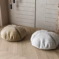 Shell Shaped Cushions in Beige and White on Herringbone Wooden Floor with Potted Plant