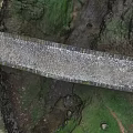 Garden Landscape Featuring Stone Bridge Cobblestone Path Green Grass And Stream