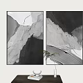 Black And White Abstract Paintings Hanging On Wall With Green Plant And Vase