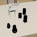White Deer Decor With Glass Candle Holders And Lit Candles On Metal Stands