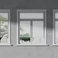 Modern Building Exterior With Multiple White And Black Casement Windows And Green Plants