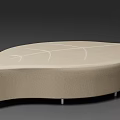 Beige Upholstered Ottoman With Irregular Shape And Line Pattern On Metal Legs