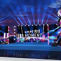 Eye Catching Stage Design With Colorful Lights Large Screens And MOMENT Text Elements
