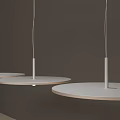 FLOS Round White Pendant Light Hanging Above Modern Table In Showroom Interior