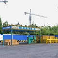 Construction Site Vehicle Washing Shed with Blue Roof Yellow Railings Wooden Crates and Tower Cranes