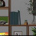 Stacked Light Blue Books with Small Green Decor Piece on Gold Base