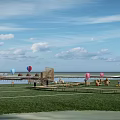 Scenic Outdoor Leisure Spot With Green Grass Pier Striped Umbrellas And Colorful Hot Air Balloons
