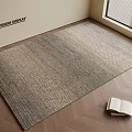 Neutral Toned Woven Square Rug on Herringbone Wooden Floor with Open Book and Light Wall