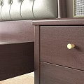 Dark Brown Wooden Double Bed with Light Green Upholstered Headboard Yellow Pillow Striped Blanket and Nightstand