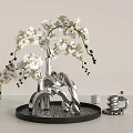 White Orchid Flowers In Silver Vase On Decorative Tray With Small Decor Items
