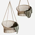 Natural Wicker Hanging Chair With Tassel Trim And Soft Green Blanket Accent
