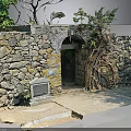 Natural Stone Wall With Arched Doorway And Wooden Tree Roots Decorative Elements