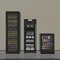 Modern Black Refrigerators With Wine Bottles Glasses Dishes And Beverage Cans Against Wall