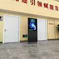 Interactive Touch Screen Digital Signage Kiosk In Indoor Public Lobby With Doors And Plants