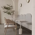 Café with Light Toned Walls Gray Curved Booths Round White Tables and Light Wooden Chairs