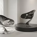 Modern Glossy Sculptural Chairs With Curved Lines On Display Stand In Interior Lighting
