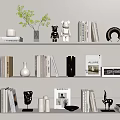 Decorative Ornament Set On White Shelves With Books Sculptures Vases And Green Plant