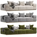 Modern Three Seater Sofa With Beige Gray Green Upholstery Pillows And Throw Blanket