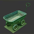 Blue Vintage Wheelbarrow with Four Rustic Wheels on Brown Mat Against Dark Background