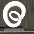 Metallic Spiral Sculpture With Perforated Pattern On Wooden Base In Dark Background