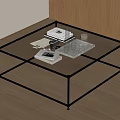 Modern Coffee Table with Glass Top Black Metal Frame and Books Camera in Living Room