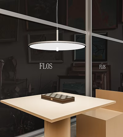 FLOS Round White Pendant Light Hanging Above Modern Table In Showroom Interior 3d model