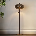Modern Floor Lamp Beside Green Plant On White Wall With Slim Pole And Round Shade
