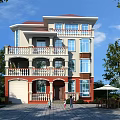 Three Story Detached Villa With Red Roof Balconies Green Yard And Paved Driveway