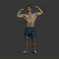Shirtless Muscular Man Flexing Muscles In Blue Shorts And Green Sneakers Against Gray Background