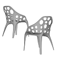 Two Modern Black Leisure Chairs with Circular Cutouts and Stylish Leg Design