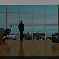 Spacious Office Interior With Large Windows Sea View Cityscape Wooden Flooring Person Standing By Window