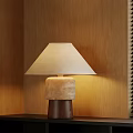 Modern Table Lamp With Beige Lampshade And Textured Brown Base On Black Cabinet