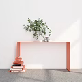 White Wall With Orange Curved Table Green Plant Book And Stack Of Orange White Books