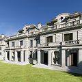Luxurious Townhouse Exterior With Stone Construction Porch Columns Symmetrical Design And Lawn Front Yard