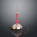 Red Tower Building With Umbrella Like Base And Illuminated Spire Top