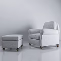 Light Gray Upholstered Armchair with Matching Ottoman and Wooden Legs in Minimalist Neutral Background