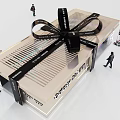 Mobile Digital Products Showcase In Modern Gift Box Shaped Booth With Black Ribbon Bow