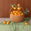 Fresh Ripe Persimmons in Wicker Basket with Green Leaves on Wooden Background and Green Cloth