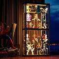 Illuminated Display Cabinet With Multiple Shelves Holding Collectible Models And Superman Statue