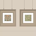 Two Beige Square Picture Frames With Floral Prints Hanging On Wall