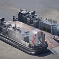 Hovercraft Warship Sailing On Sea With Large Fans And Inflatable Skirt Creating Water Splashes