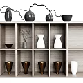 Decorative Vases In Various Colors On Wooden Shelf With Compartments And Dried Branches