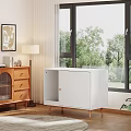 White Entryway Cabinet And Side Cabinet With Wooden Legs Near Window And Green Plants