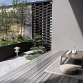 Serene Courtyard Garden With Wooden Deck Small Stone Lantern Green Plants And Low Table